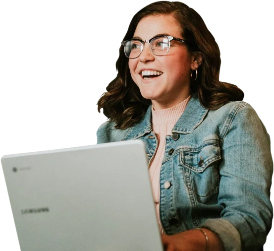 A smiling woman working on her laptop